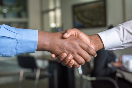 Two men shaking hands, agreeing on the contract