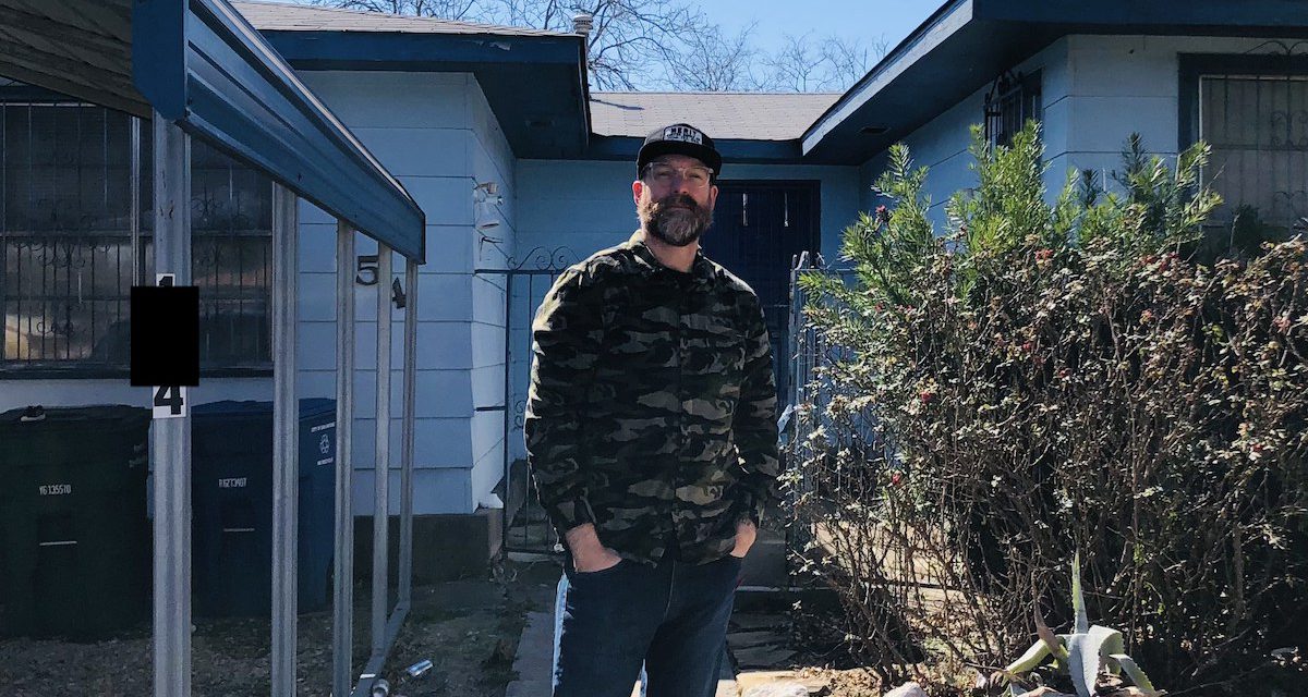 An image of a bearded man in a long shirt standing in front of a house. This MyHouseDeals member spoke about how to invest in a rental property and using the process as al learning experience.