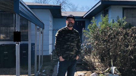 An image of a bearded man in a long shirt standing in front of a house. This MyHouseDeals member spoke about how to invest in a rental property and using the process as al learning experience.